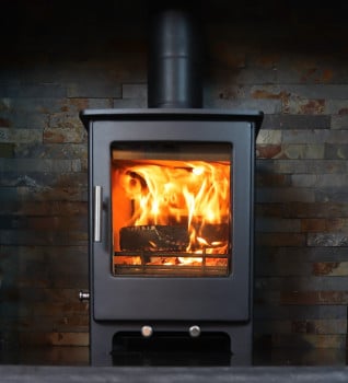 Woodford Lowry 5 Multifuel Stove Lifestyle shown fitted with a riven slate hearth and a wooden beam shot from the side