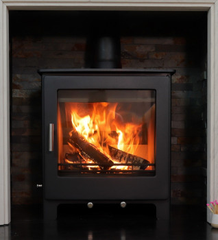 Woodford Lowry 5XL Multifuel Stove Shown within a Limestone Surround with a tiled chamber