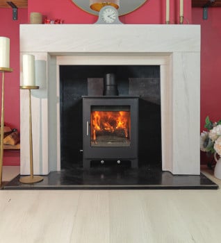 Woodford Lowry 5X Multifuel Stove Shown in a Limestone Surround with a tiled chamber